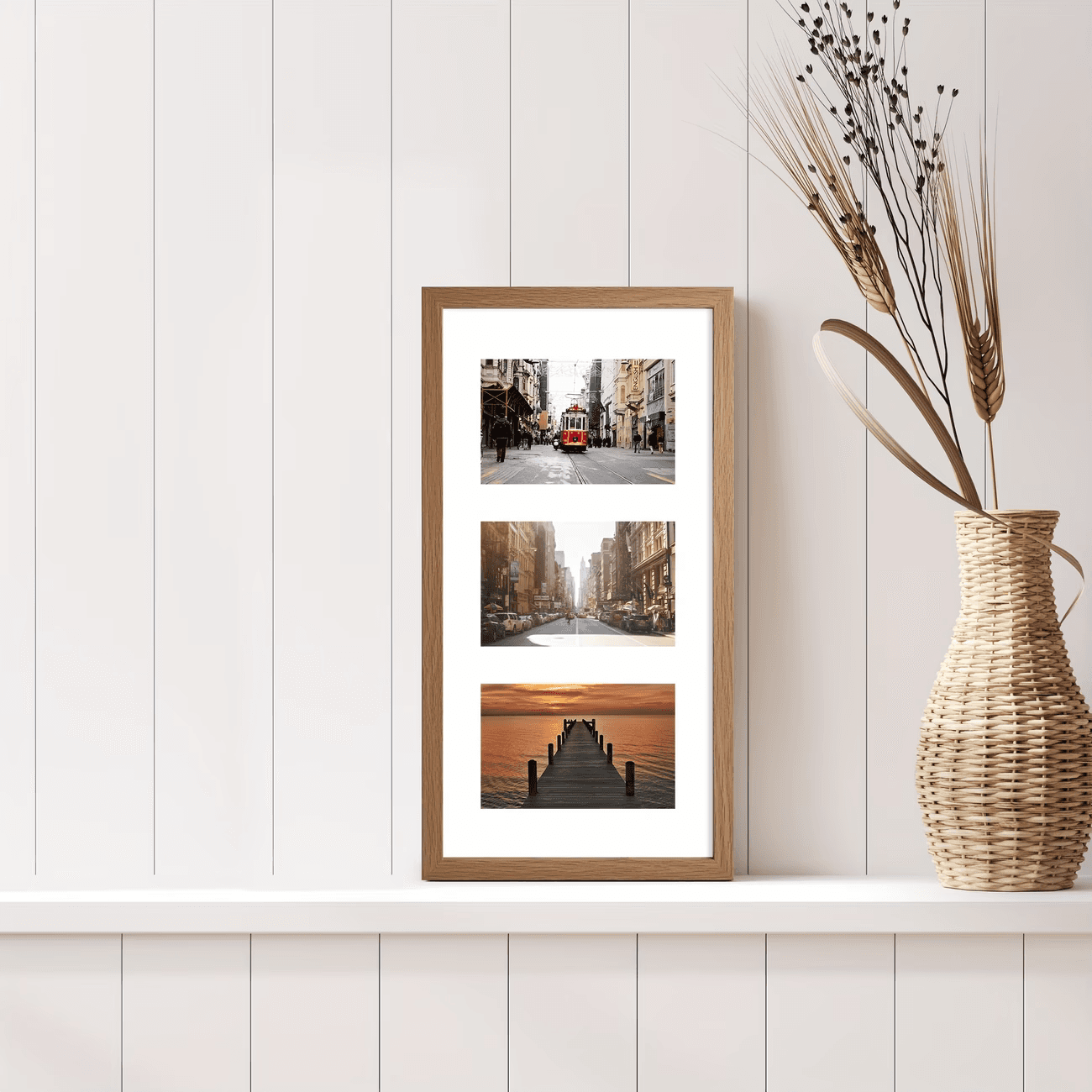 An oak triple frame of city and sunset photos on a shelf